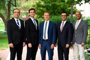 Ehsan Azimi, Luke Osborn, John Hickey, Javad Fotouhi, and Farshid Alambeigi pose wearing formal suits.