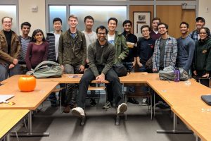 Anand Malpani poses with students in a Gilman Hall classroom.