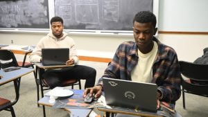 HopHacks students with laptops.