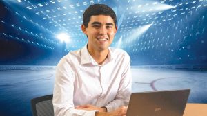 An image of Tad Berkery with his laptop is superimposed over a hockey rink.