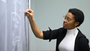 HopHacks student at a chalkboard.