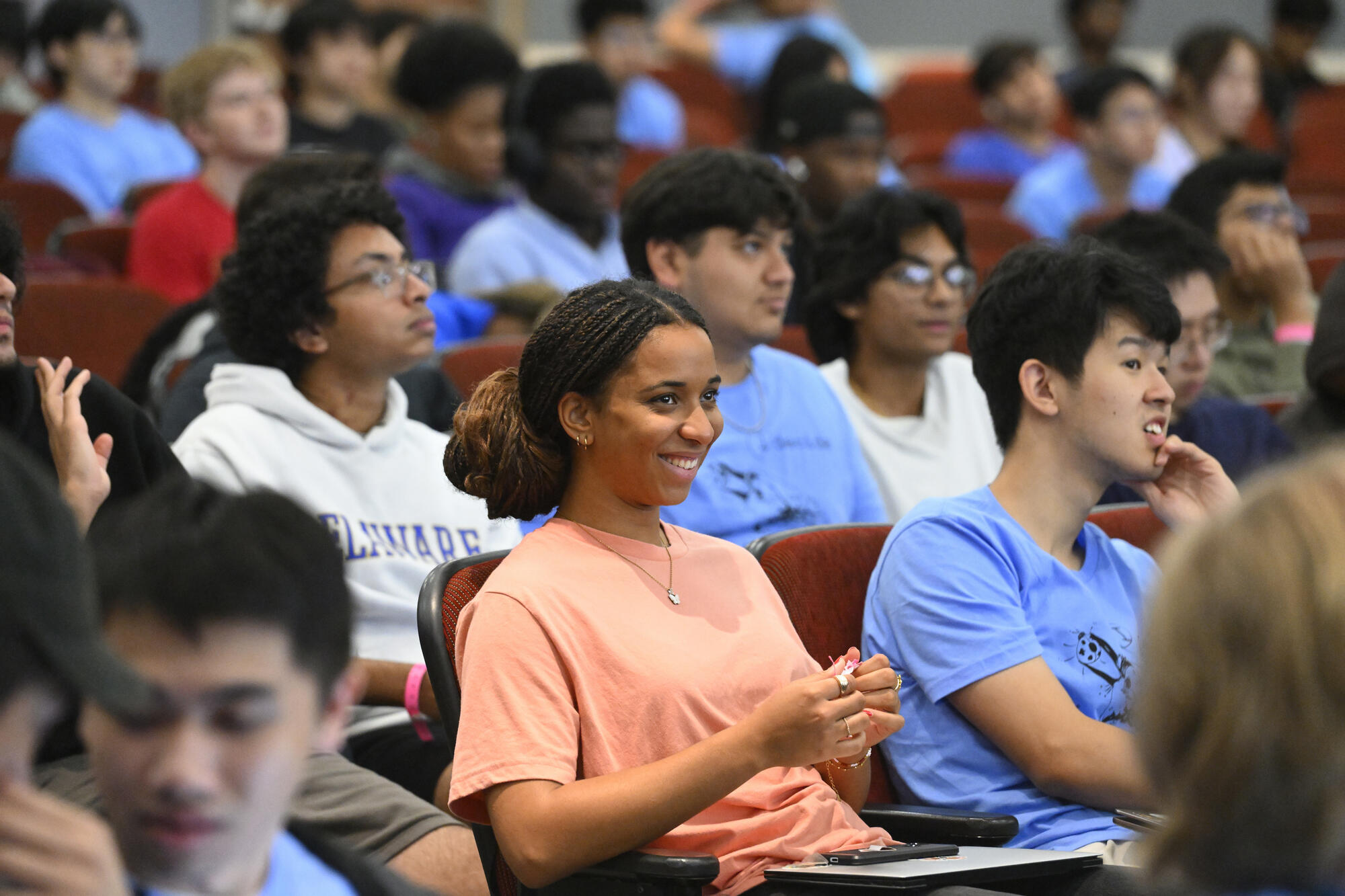 A student smiles in the audience in Hodson 110.