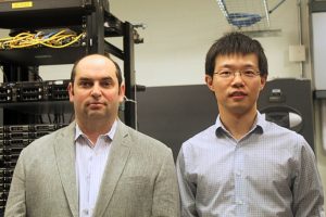 Vladimir Braverman and Xin Jin pose in a server room.