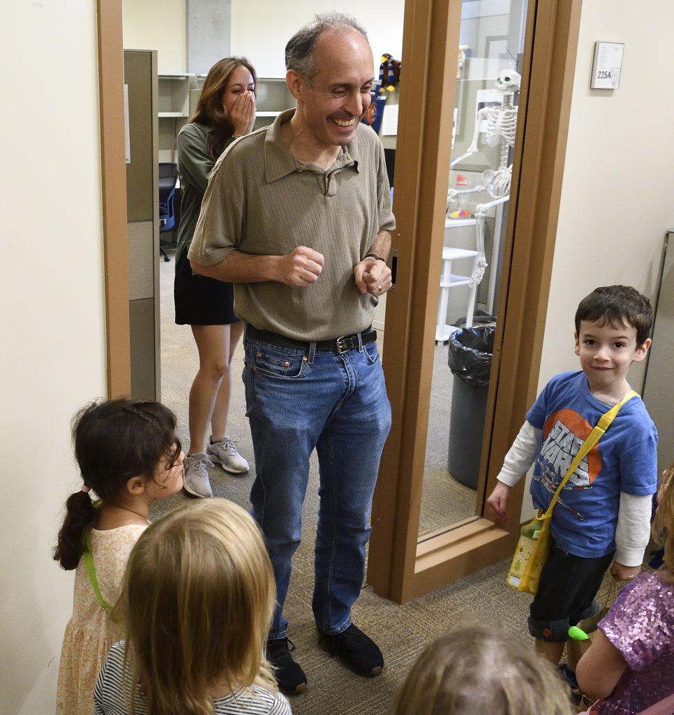 Jason Eisner greets young trick-or-treaters.