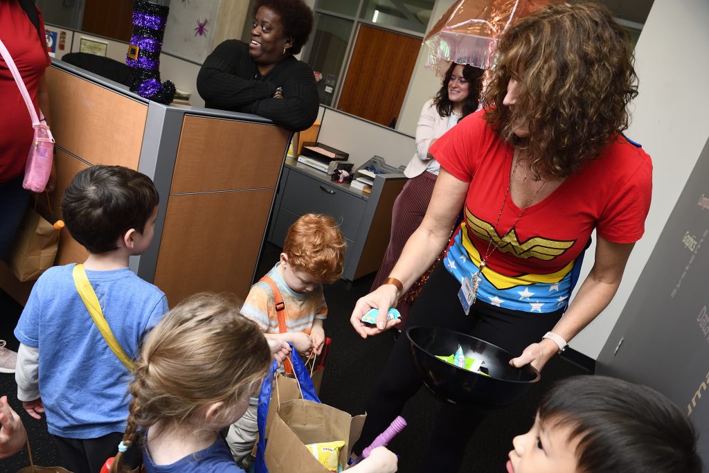 CS office staff give candy to visiting HELC trick-or-treaters.