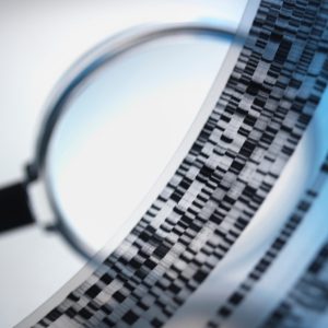 A magnifying glass over a DNA sequence.