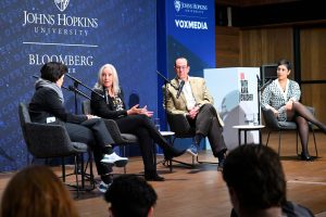 Gillian Hadfield, Mark Dredze, Kara Swisher, and Rumman Chowdhury converse while sitting on a stage.